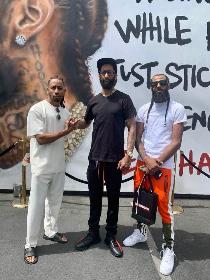 Pretty Brandao at the Nipsey Hussle memorial mural in Los Angeles
