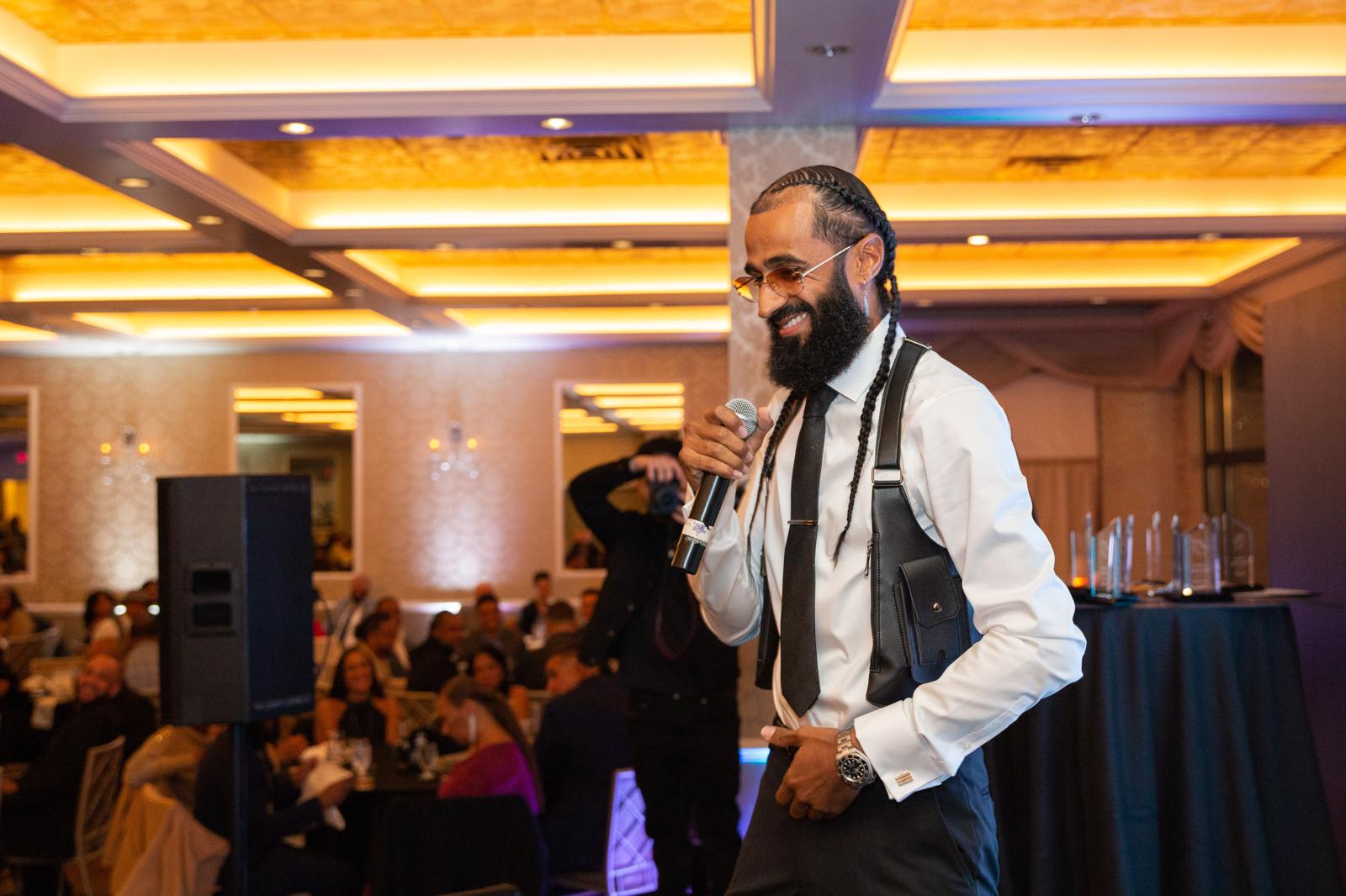 Wide shot of Pretty Brandao addressing an event audience